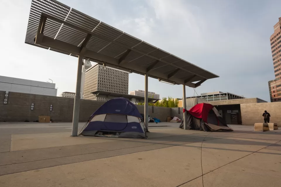 Unhoused tents under shade canopies in downtown Los Angeles, California